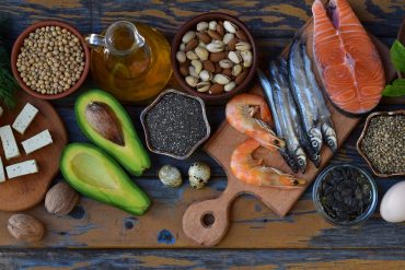Composition of products containing unsaturated fatty acids Omega 3 - fish, nuts, tofu, avocado, egg, soybeans, flax, pumpkin seeds, chia, hemp, cauliflower, dill, vegetable oil. Top view. Healthy food