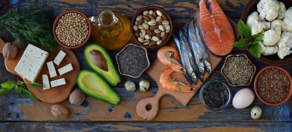 Composition of products containing unsaturated fatty acids Omega 3 - fish, nuts, tofu, avocado, egg, soybeans, flax, pumpkin seeds, chia, hemp, cauliflower, dill, vegetable oil. Top view. Healthy food